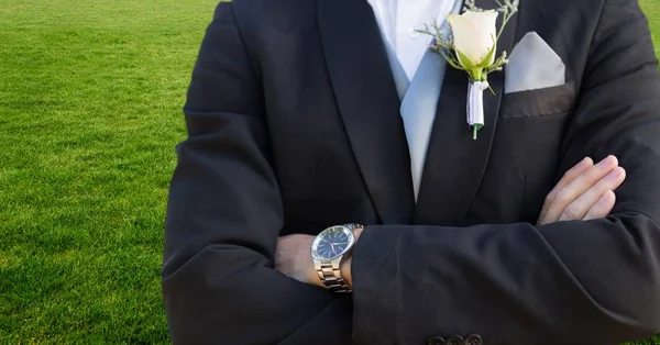 Groom mid section with arms folded against grass — Stock Photo, Image