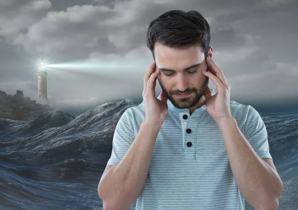 Stressed upset man next to hopeful lighthouse — Stock Photo, Image