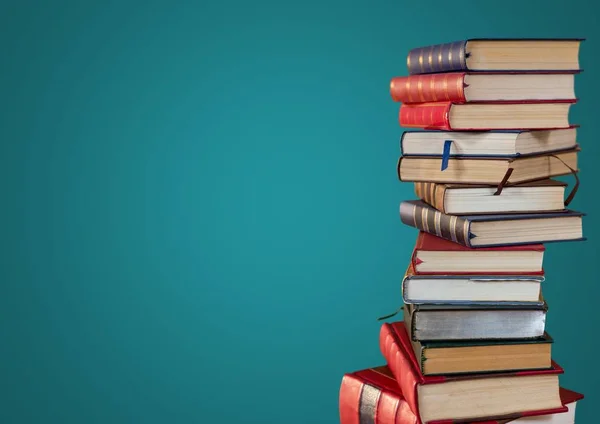 Pile of books against teal background — Stock Photo, Image