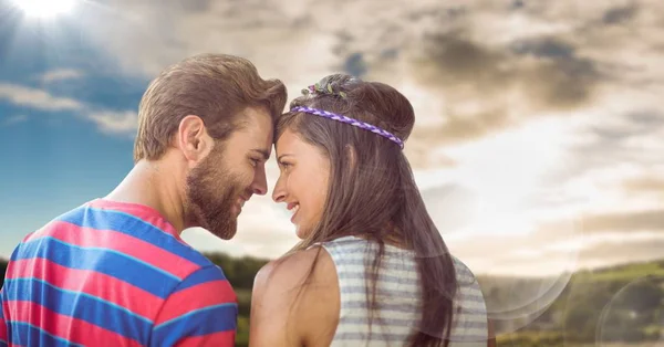 Hippie couple with flare against sky and hills — Stock Photo, Image