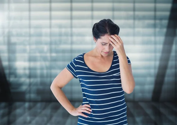 Stressed woman against windows — Stock Photo, Image