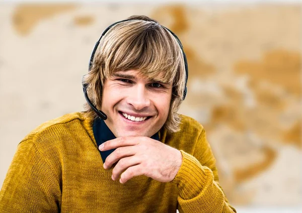 Travel agent in headset against brown blurry map — Stock Photo, Image