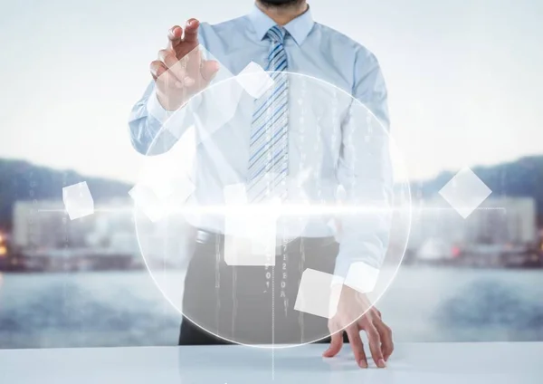 Business man at desk with white interface against blurry skyline — Stock Photo, Image