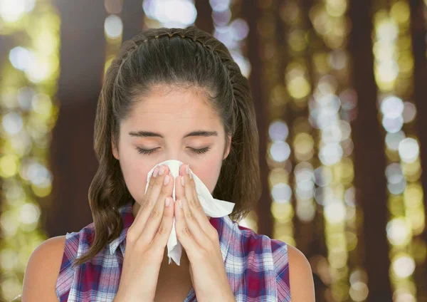 Young woman with hayfever blowing nose in forest trees — Stock Photo, Image