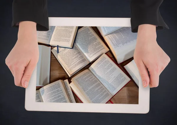 Hands with tablet on navy table showing open books — Stock Photo, Image