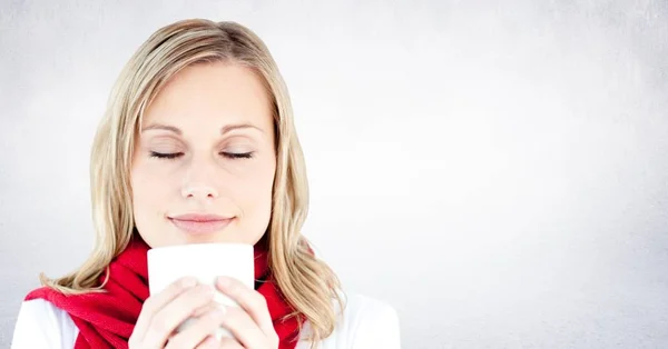 Close up of woman with white mug against white wall — Stock Photo, Image