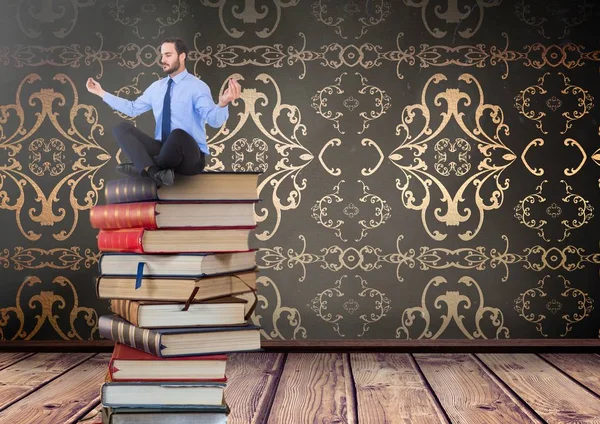 Businessman sitting meditating on Books stacked by decorative wallpaper antique — Stock Photo, Image