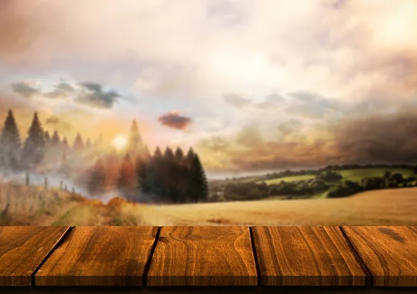 Houten tafel tegen landschap met pijnbomen — Stockfoto