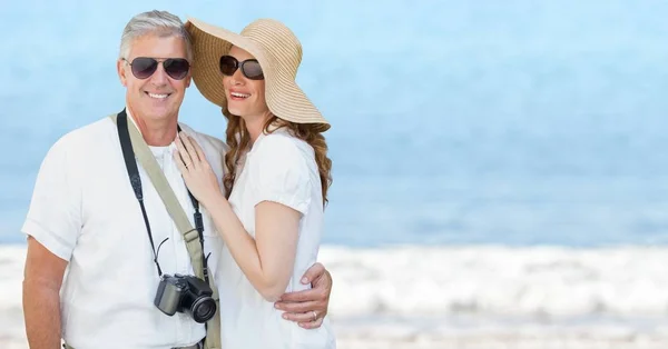 Couple summer clothes against blurry beach — Stock Photo, Image