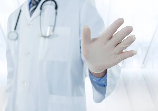 Doctor mid section with hand out against blurry window — Stock Photo, Image