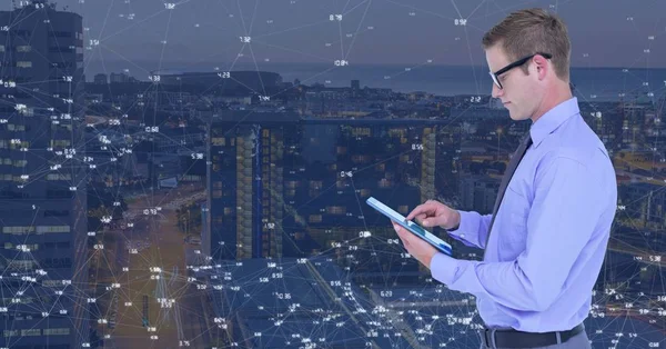 El hombre en la tableta contra la ciudad de noche con conectores — Foto de Stock