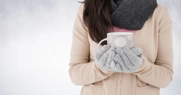 Mujer sección media sosteniendo taza de lunares contra la pared blanca — Foto de Stock