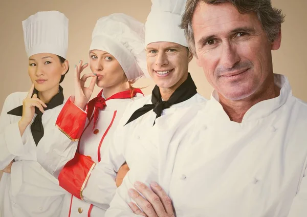 Four chefs against cream background — Stock Photo, Image