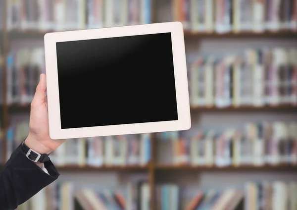 Mans hand holding tablet in Library — Stock Photo, Image