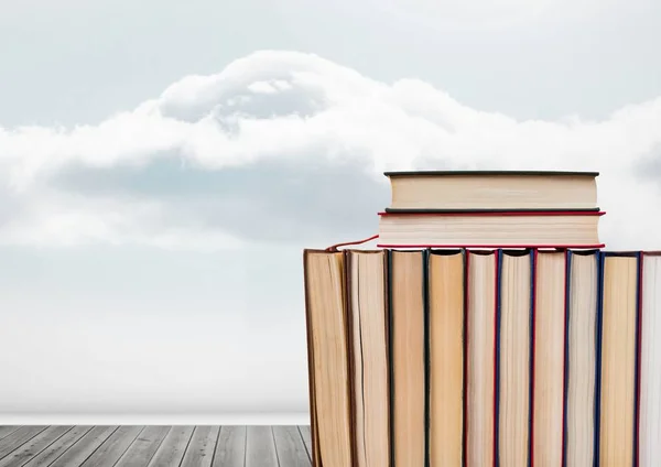 Libros apilados por el cielo nublado — Foto de Stock