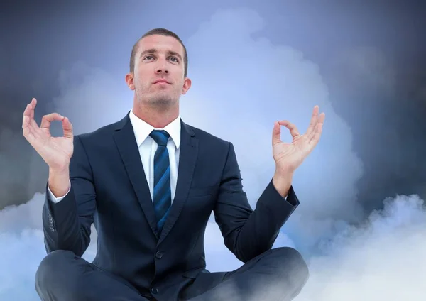 Businessman Meditating with clouds — Stock Photo, Image