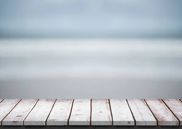 White wood table against blurry beach — Stock Photo, Image