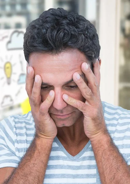 Upset man against light bulb cloud — Stock Photo, Image