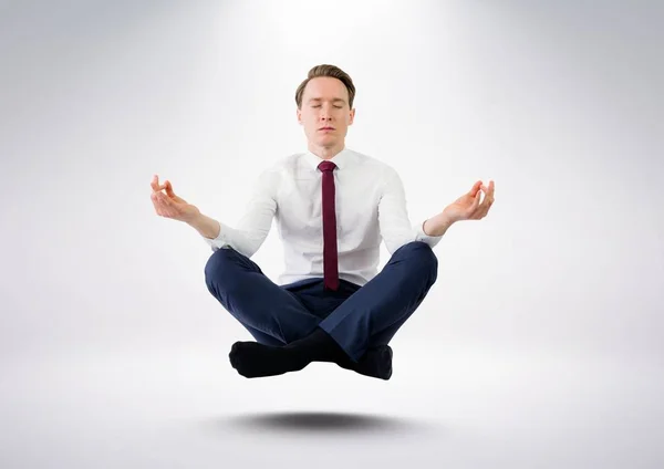 Empresário Meditando flutuando contra fundo cinza — Fotografia de Stock