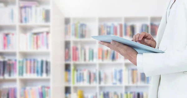 Kvinnans händer på tablett i biblioteket — Stockfoto