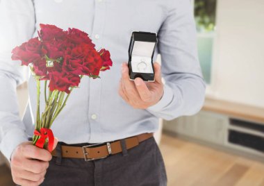 Man holding engagement ring and flowers in room clipart