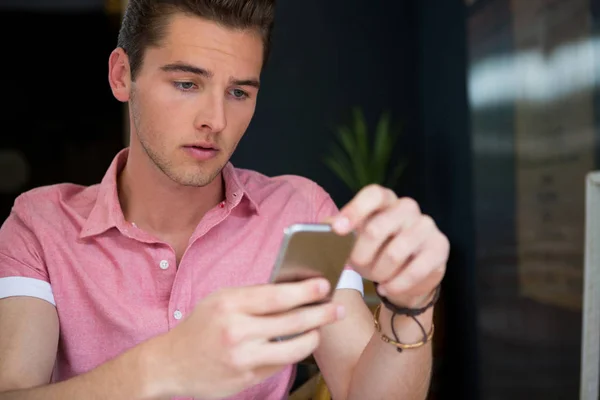 Hombre usando el teléfono móvil en la cafetería — Foto de Stock