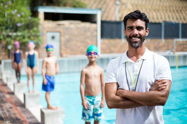 stock image Instructor while children standing on starting block