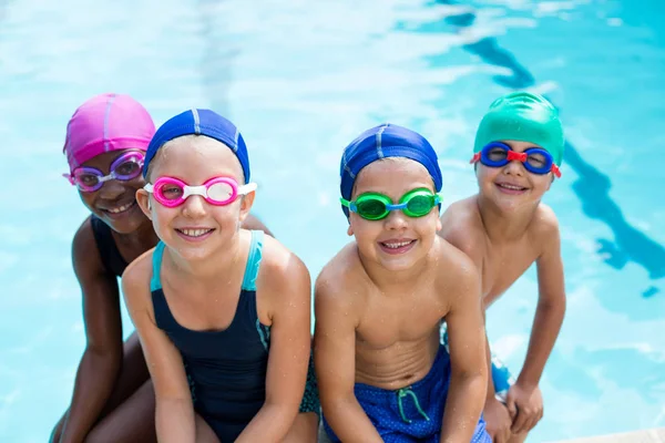 Little swimmers sitting at poolside — Stock Photo, Image