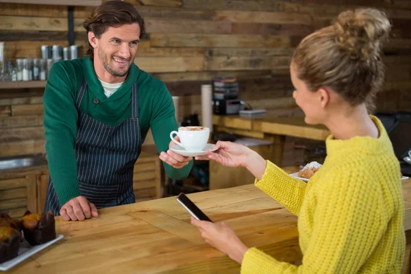 Barista sirviendo café a cliente femenino — Foto de Stock