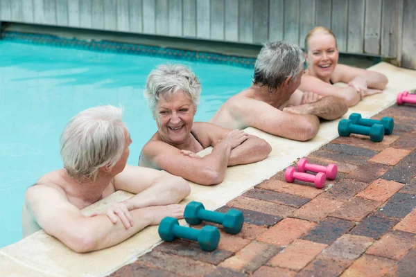 Cheerful swimmers leaning on poolside — Stock Photo, Image