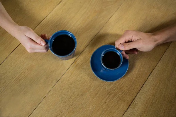 Couple hands holding coffee cups — Stock Photo, Image
