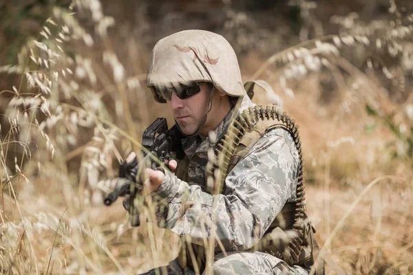 Military soldier hiding in grass — Stock Photo, Image