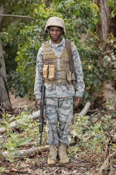 Confident military soldier standing with rifle — Stock Photo, Image