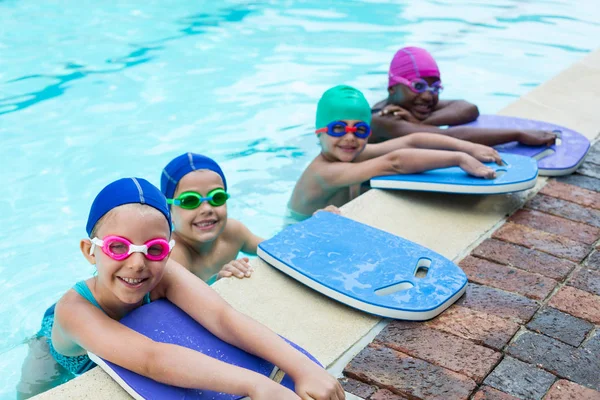Little swimmers with kickboards at poolside — Stock Photo, Image