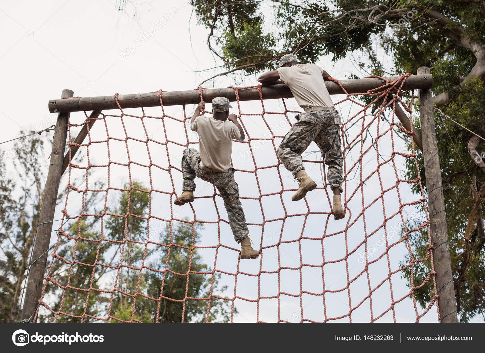 Military soldier climbing a net Stock Photo by ©Wavebreakmedia 148232263