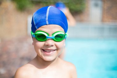 Little boy wearing swimming goggle and cap  clipart