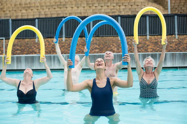 Trainer and senior swimmers exercising — Stock Photo, Image