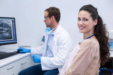 Female patient smiling at camera clipart