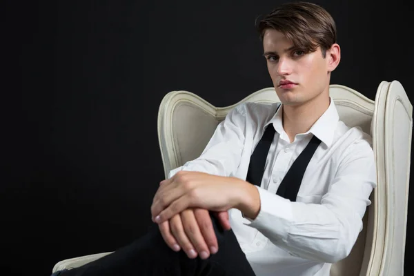 Androgyner Mann sitzt auf Stuhl — Stockfoto