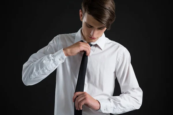 Androgynous man adjusting his tie — Stock Photo, Image