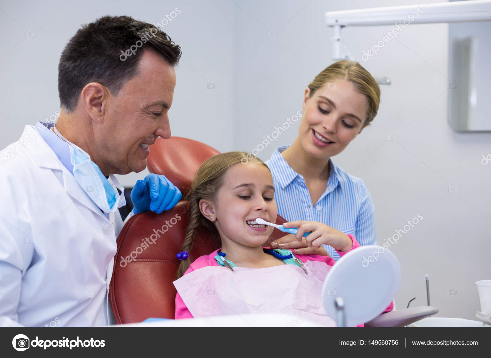 Dentist assisting patient while brushing teeth — Stock Photo