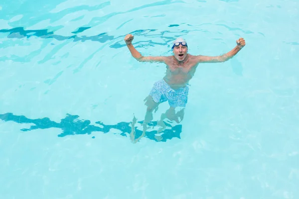 Excited senior man standing in swimming pool — Stock Photo, Image