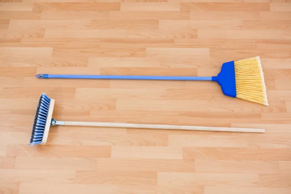 Hgh angle view of long handle brooms — Stock Photo, Image