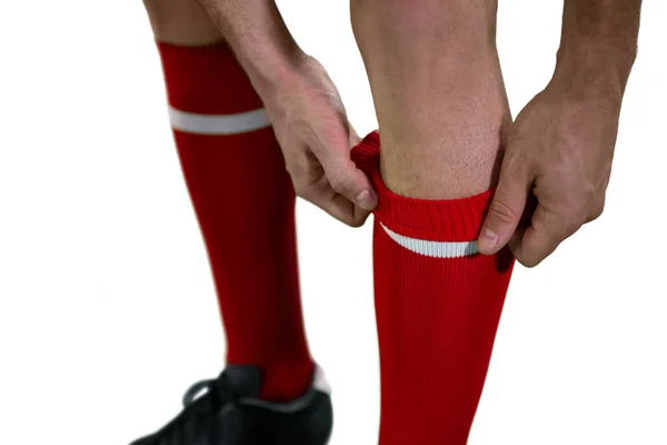 Football player pulling his socks up — Stock Photo, Image