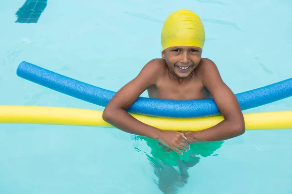 Улыбающийся мальчик плавает в бассейне — стоковое фото
