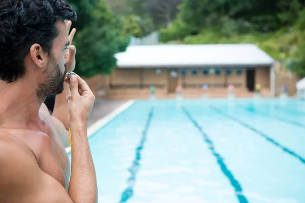 Bagnino guardando piscina e soffiando fischio — Foto Stock