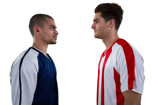 Two rival football player looking at each other — Stock Photo, Image