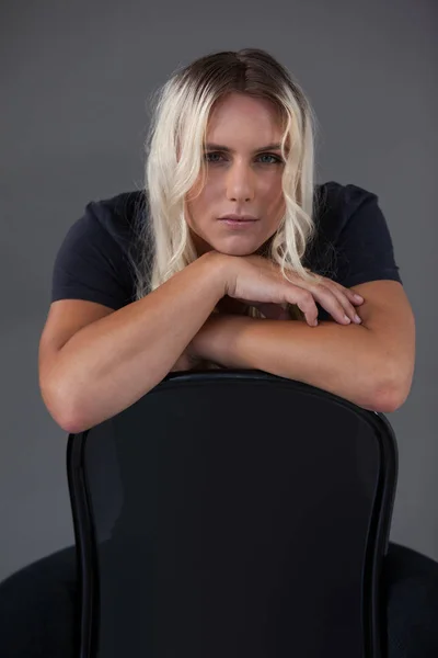 Transgender woman leaning on chair — Stock Photo, Image