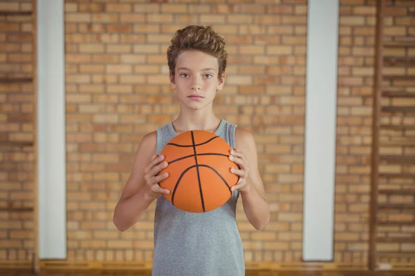 Determined boy holding a basketball — Stock Photo, Image