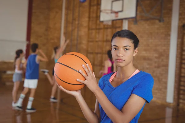 Colegial menina segurando basquete — Fotografia de Stock